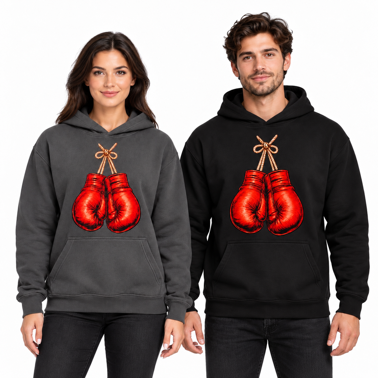 Female and male models wearing charcoal grey and black hoodies with red boxing gloves graphics against a white studio background.