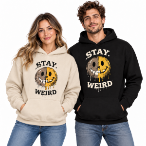 Two models wearing Stay Weird melting smiley face hoodies in stone with black lettering and black with cream lettering.
