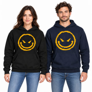 Female and male models wearing black and dark navy hoodies with distressed yellow sinister smiley face graphics on a white studio background.